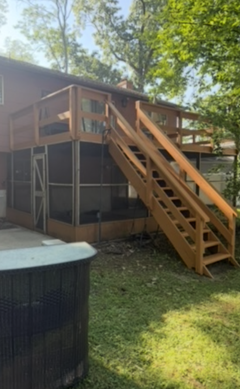 Deck staircase after rebuild — solid new stairs with smooth handrails and warm stain finish